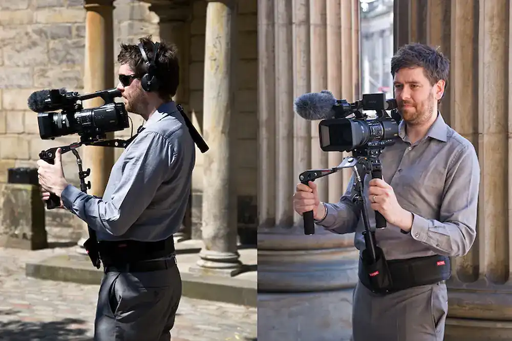 Jonathon Fowler operating a professional camera with stabilizer outdoors, wearing a headset and belt support, standing near pillars.