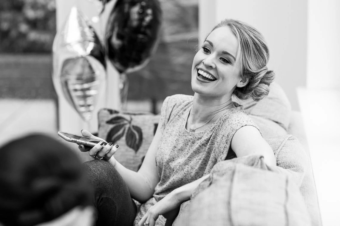 bridesmaid laughing sitting on a chair