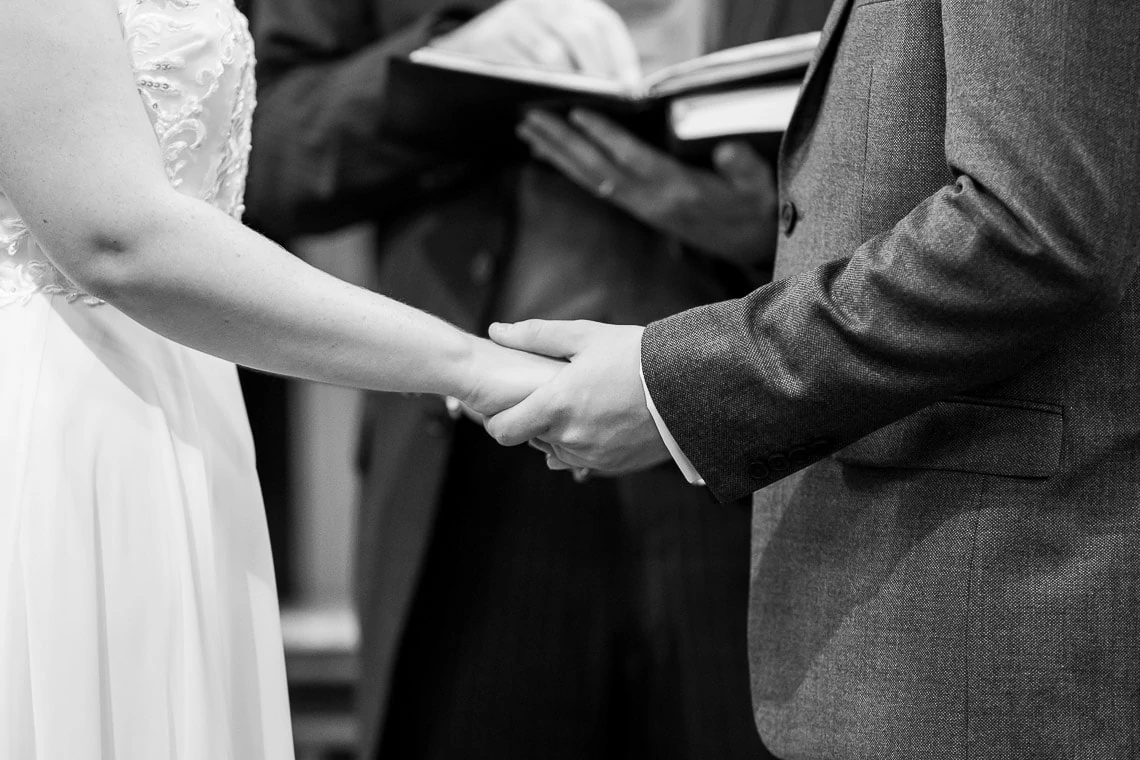 holding hands during exchange of vows during ceremony at Liberton Kirk