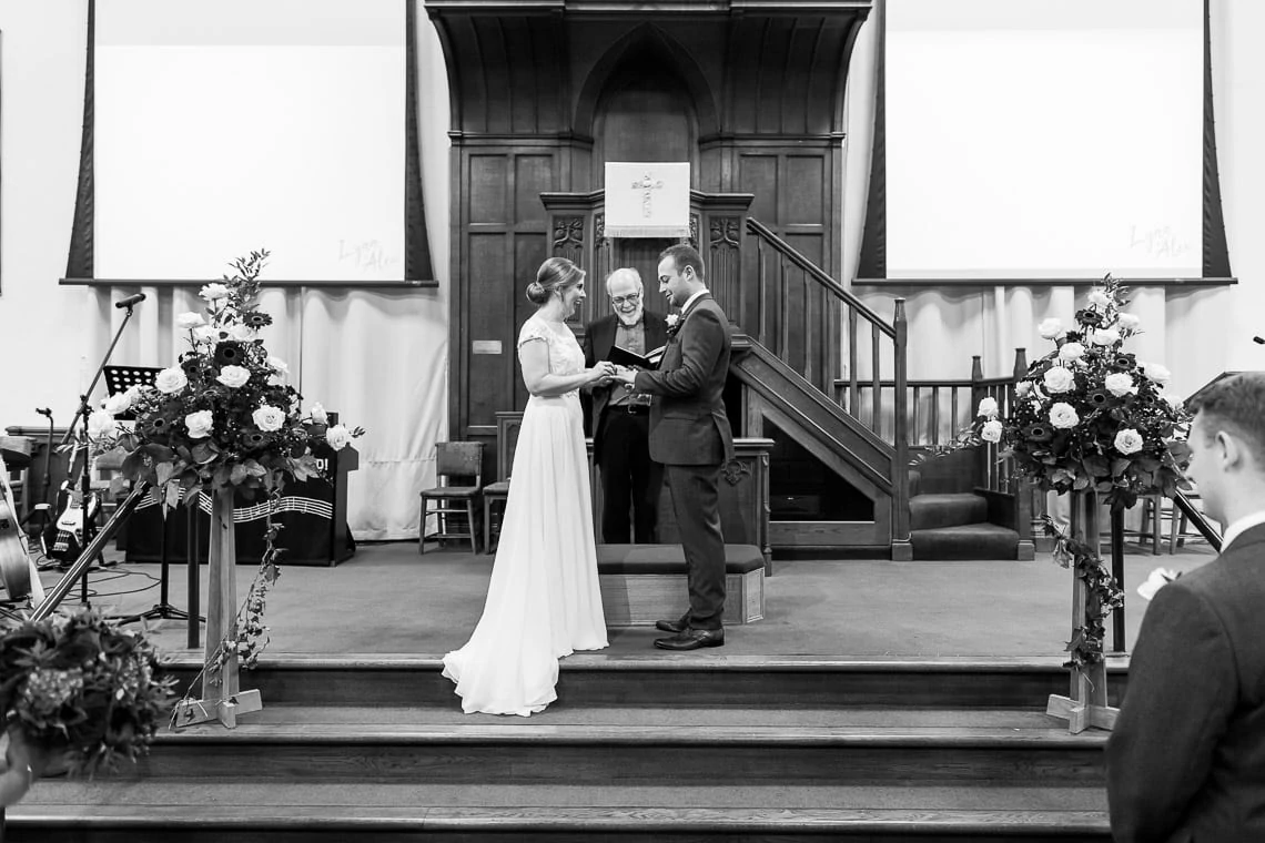 exchange of rings during ceremony at Liberton Kirk