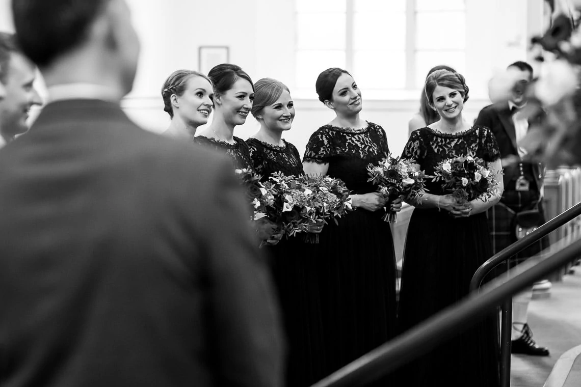 bridesmaids watching the exchange of rings during ceremony at Liberton Kirk