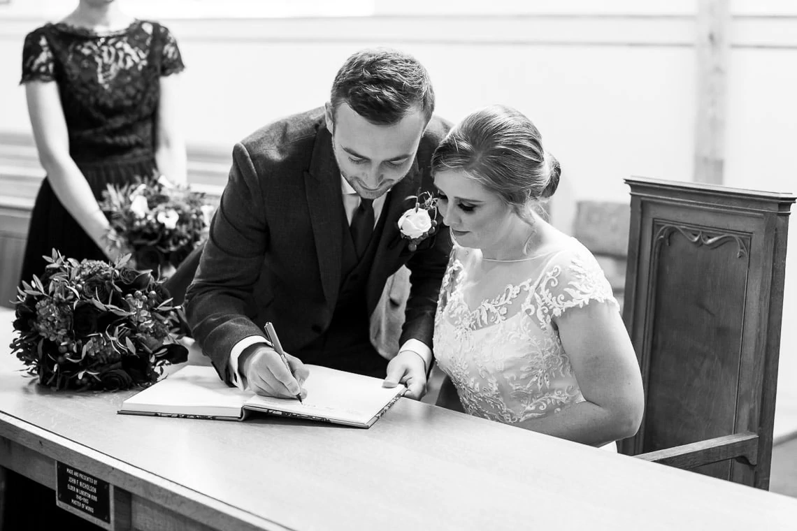 newlyweds sign the marriage schedule at Liberton Kirk