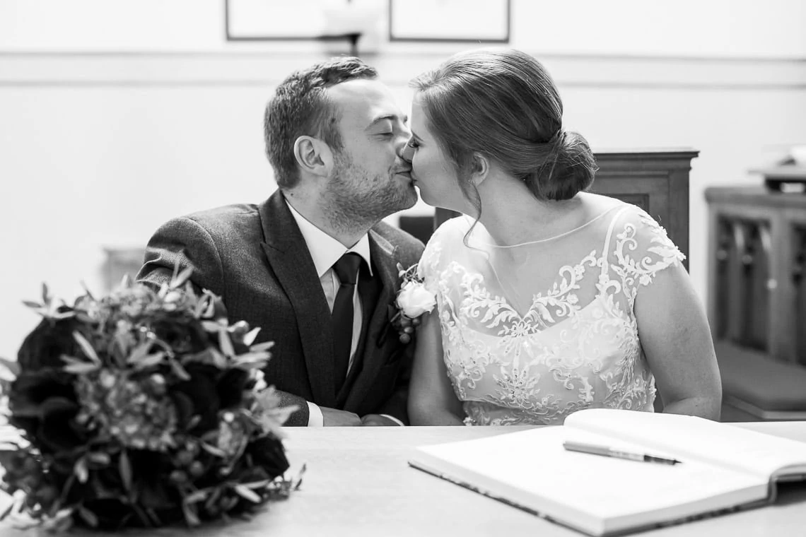 newlyweds kiss after signing the marriage schedule at Liberton Kirk