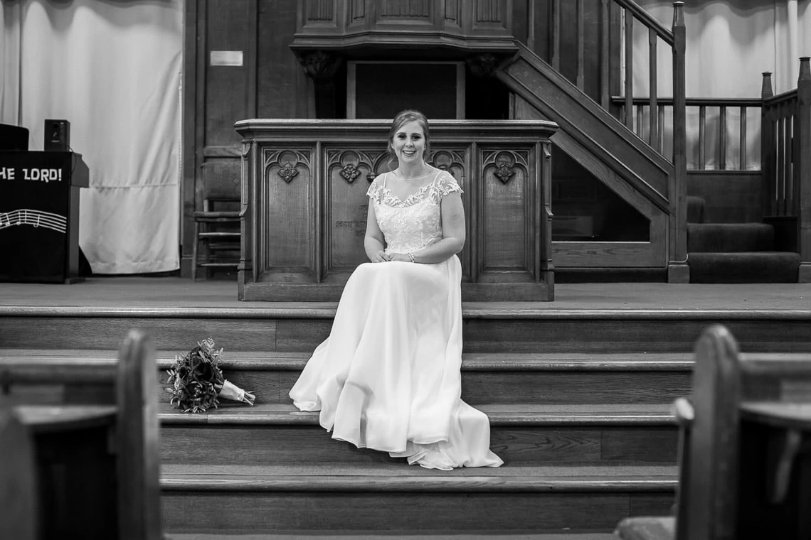 bride sitting on the altar