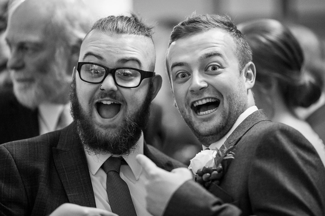 George Hotel Library champagne reception guest and groom laughing