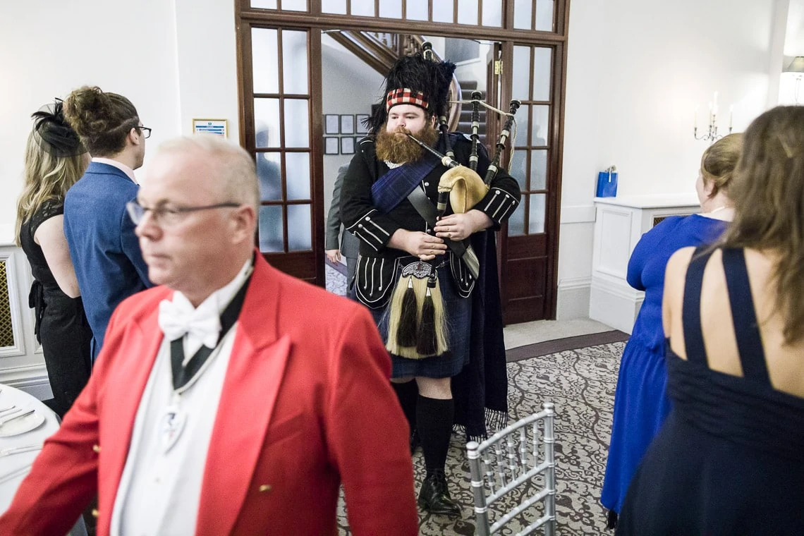 Toastmaster Maurice King leads the newlyweds as they enter the King's Hall