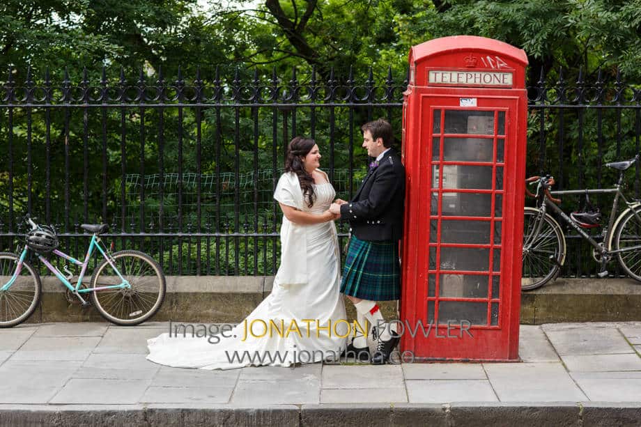Nick and Michelle pose by a red telephone box