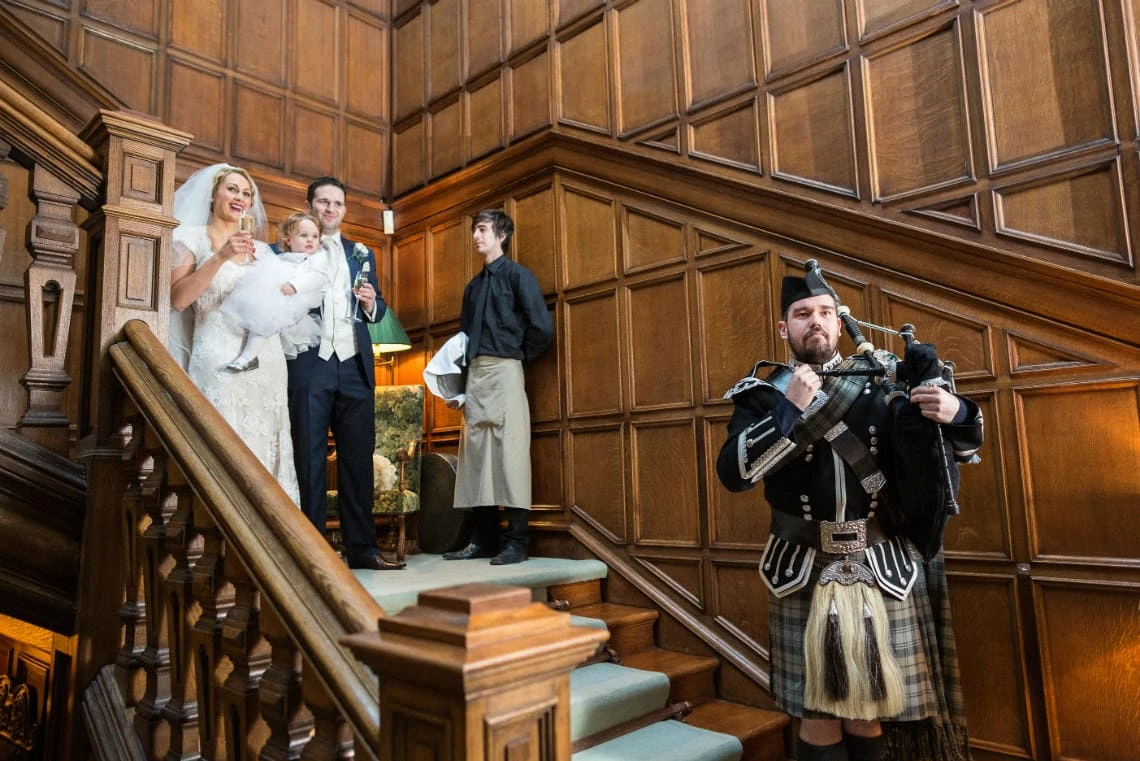 Main Hall Staircase newlyweds are announced by the piper