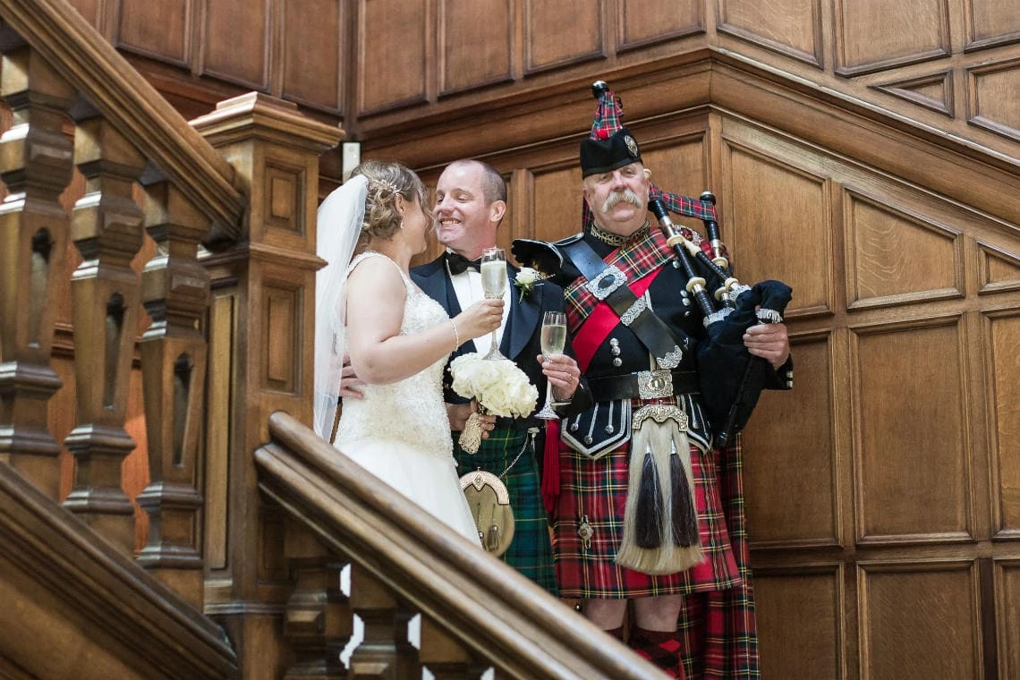 Main Hall Staircase piper announces the newlyweds
