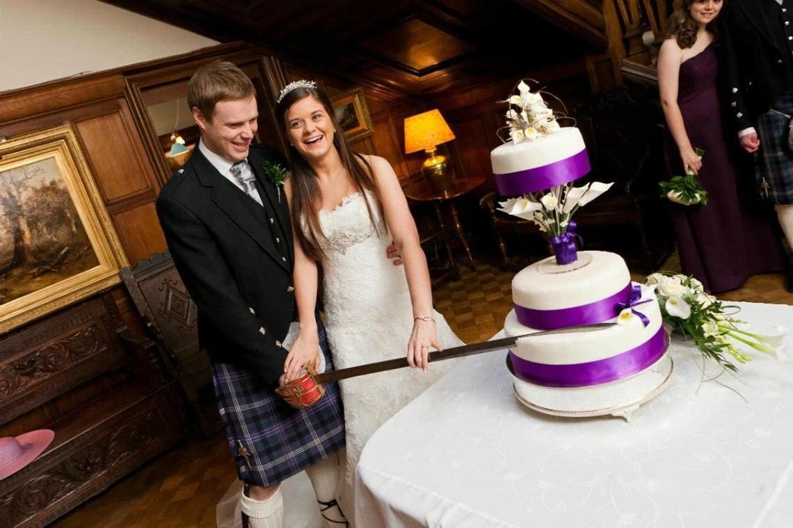Main Hall newlyweds cut the cake with a sword