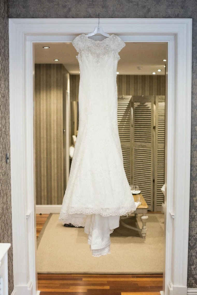 bride's dress hanging up in the Nira Caledonia hotel bedroom