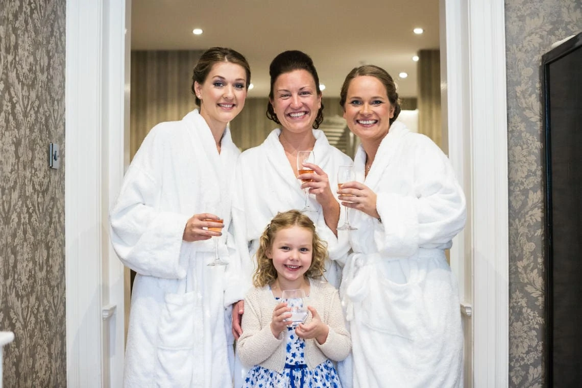 bride, bridesmaids and flower girl in bath robes at Nira Caledonia
