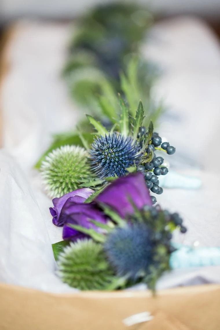 groom's buttonhole for wedding thistle and purple ribbon