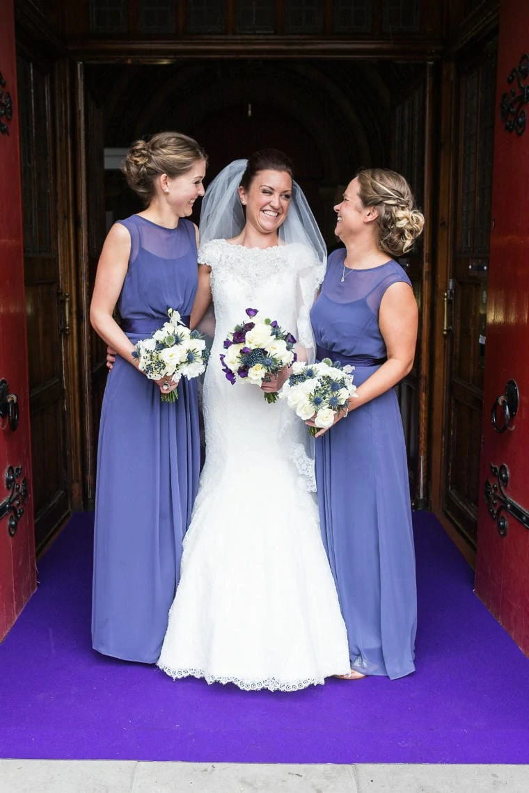 bride and bridesmaids at the entrance to Mansfield Traquair