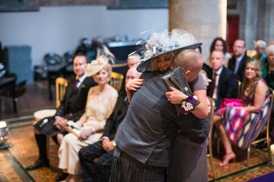 groom embraces mother of the bride