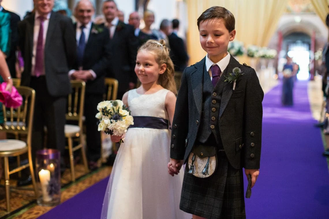 flowergirl and pageboy walking up the aisle