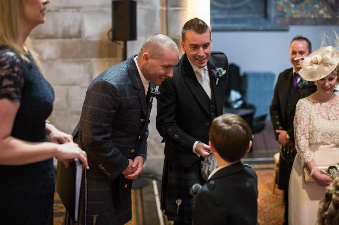 groom welcomes flowergirl and pageboy