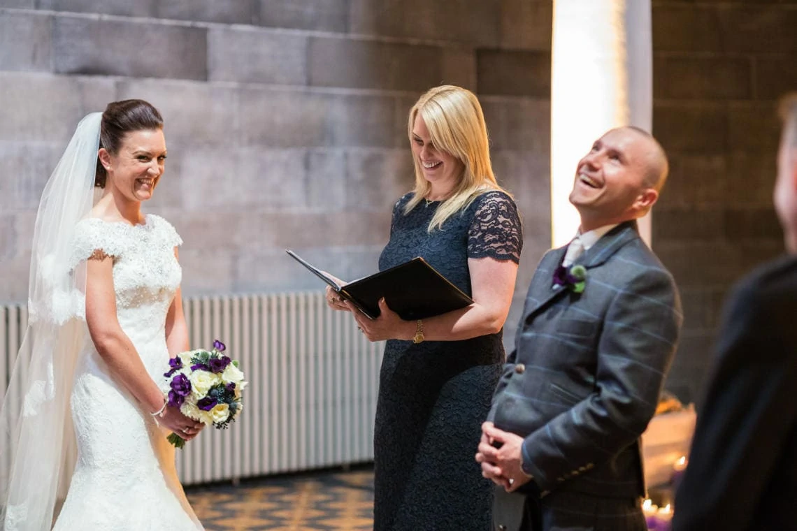 bride, groom and celebrant laughing