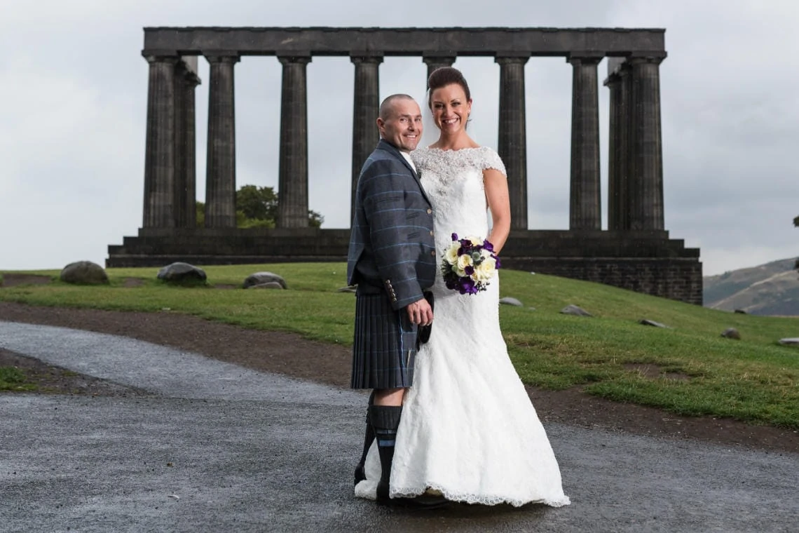 newlyweds standing in front of the National Monument on Calton Hill