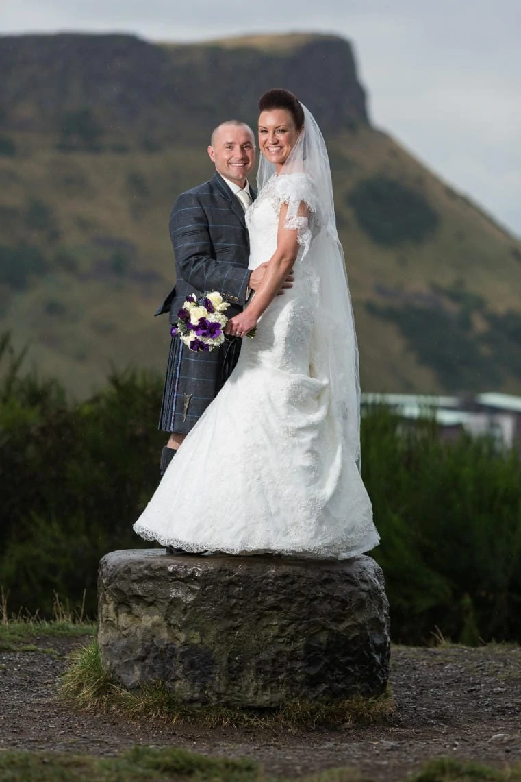 newlyweds on Calton Hill with Arthur's Seat in the background
