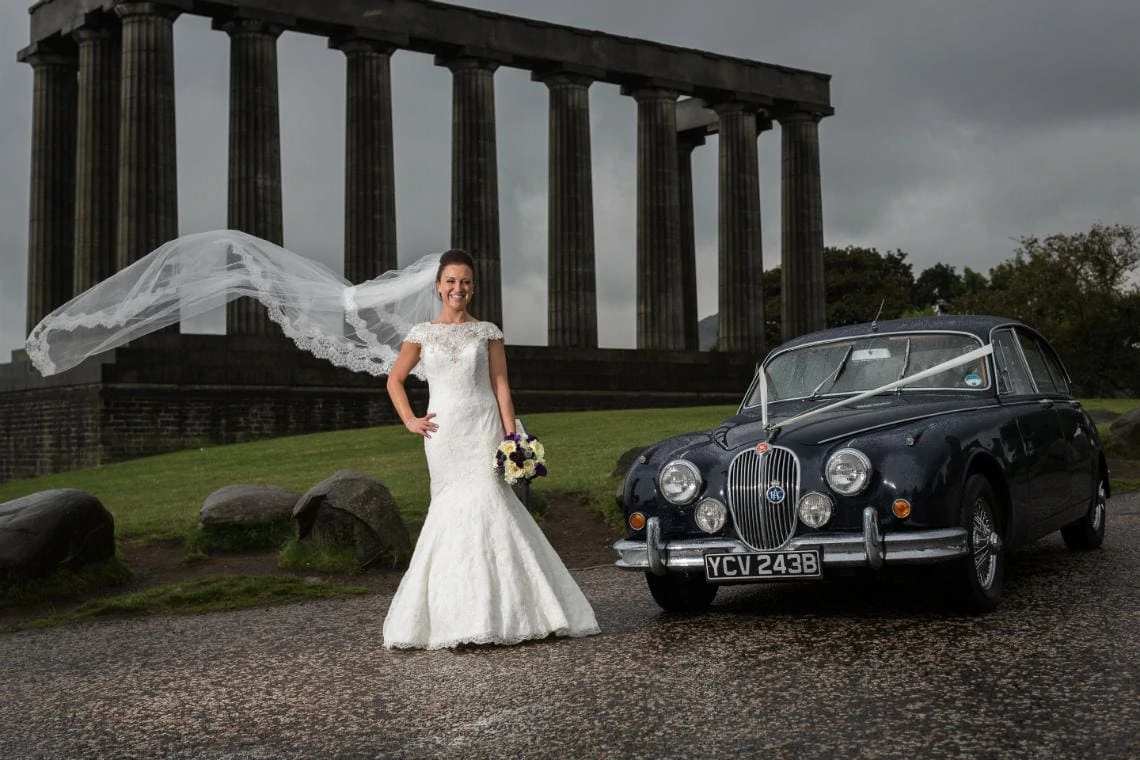 bridal veil photo on Calton Hill next to a classic Mark 2 Jaguar with the National Monument in the background