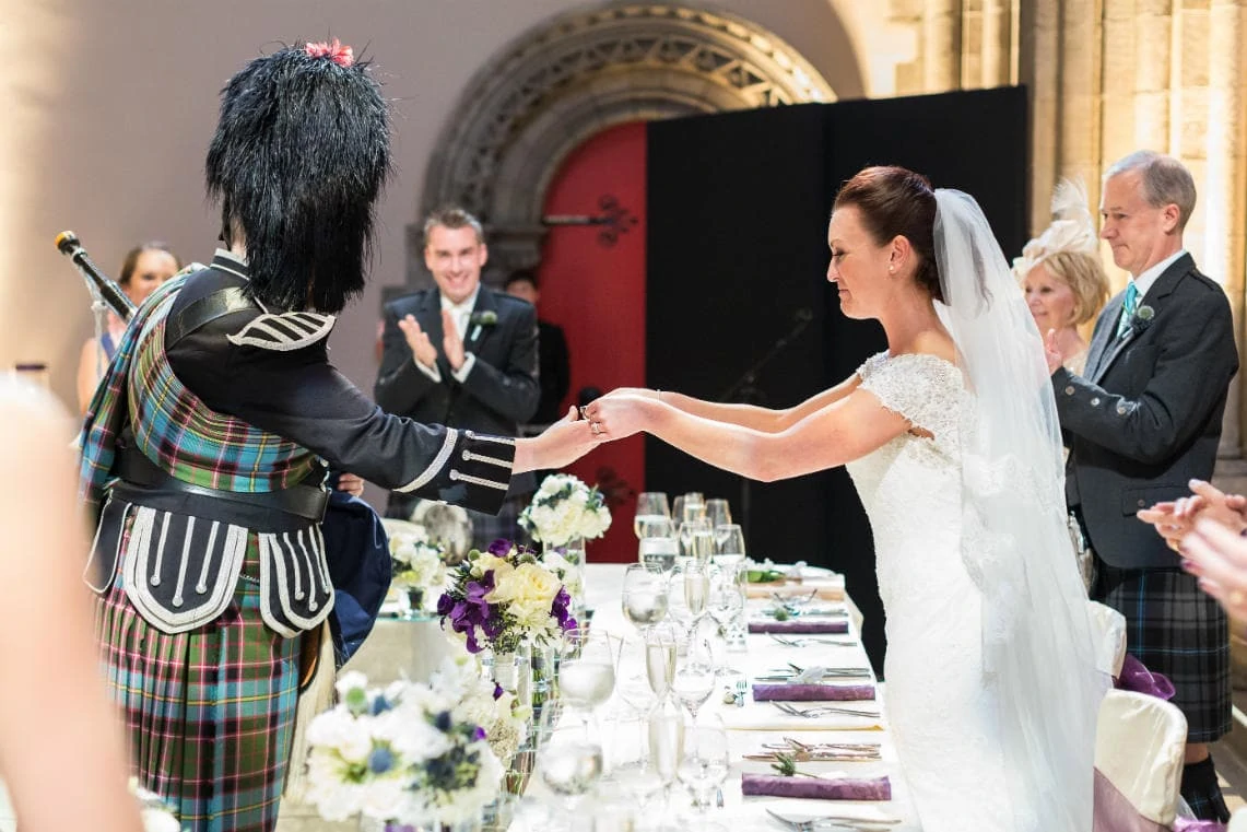 the bride presents a dram of whisky to the piper