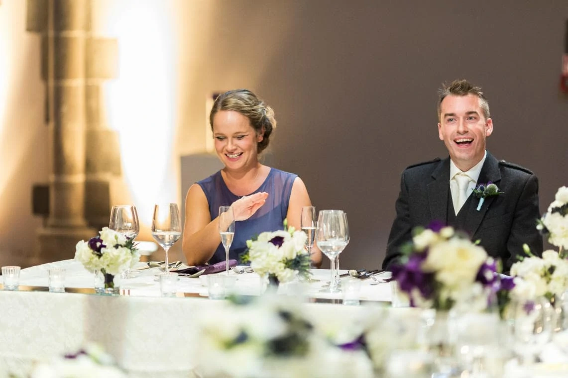 bridesmaid and best man laughing during groom's speech
