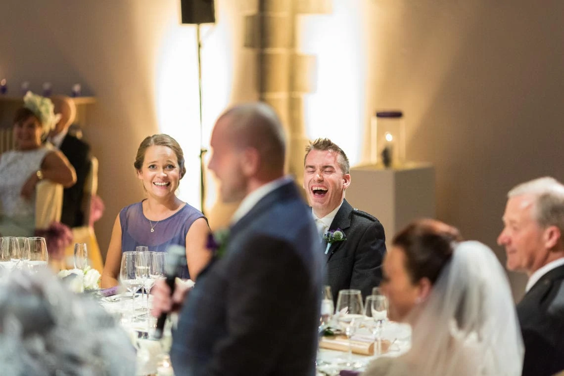 best man laughing during groom's speech