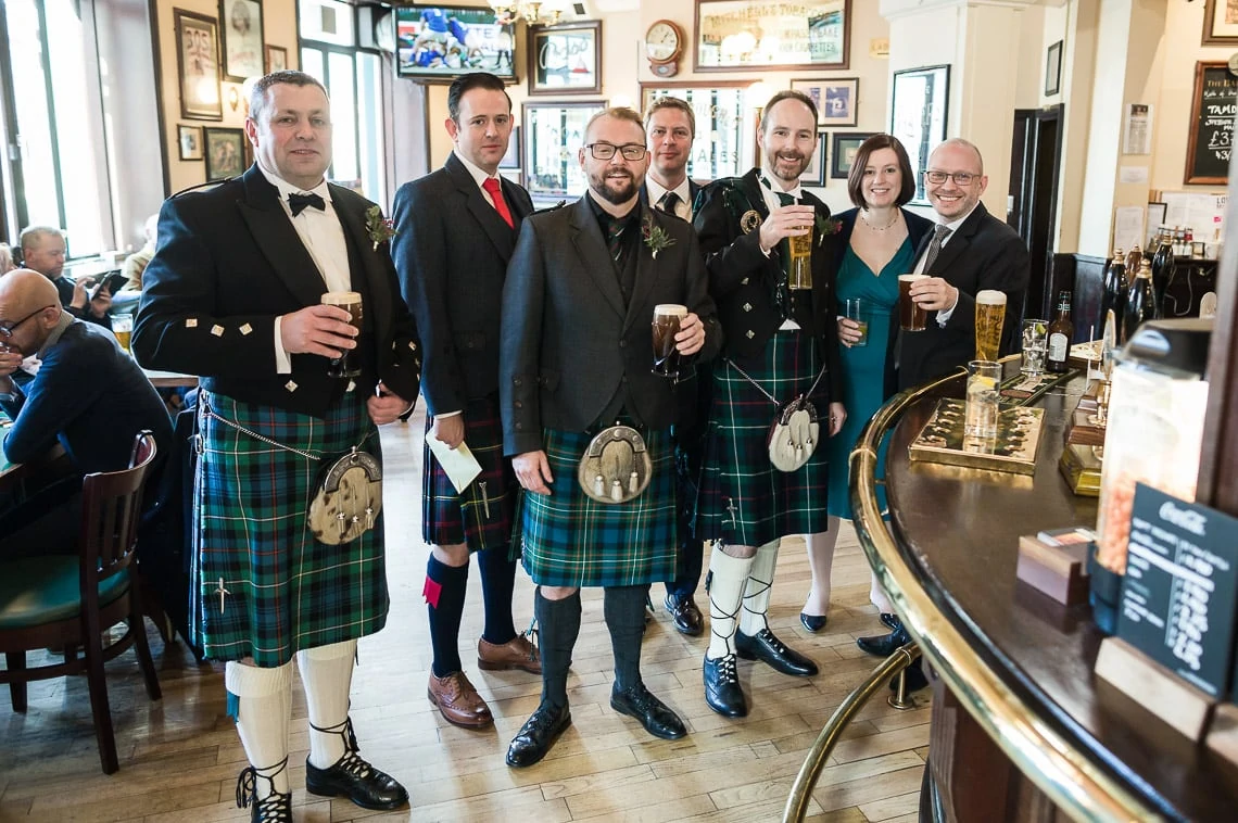 Groom and friends enjoying a pint at the Cask and Barrel pub