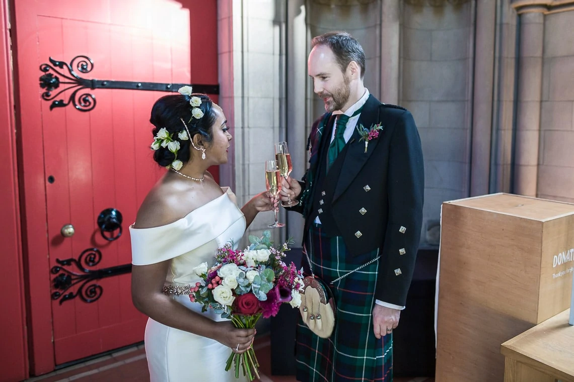 Mansfield Traquair Wedding Photos - Nithya and Ross celebratory toast of champagne