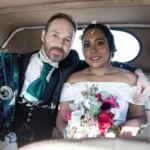 newlyweds sat in the back of a Beauford wedding car