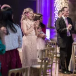 guests applaud bride and groom making their way to the top table