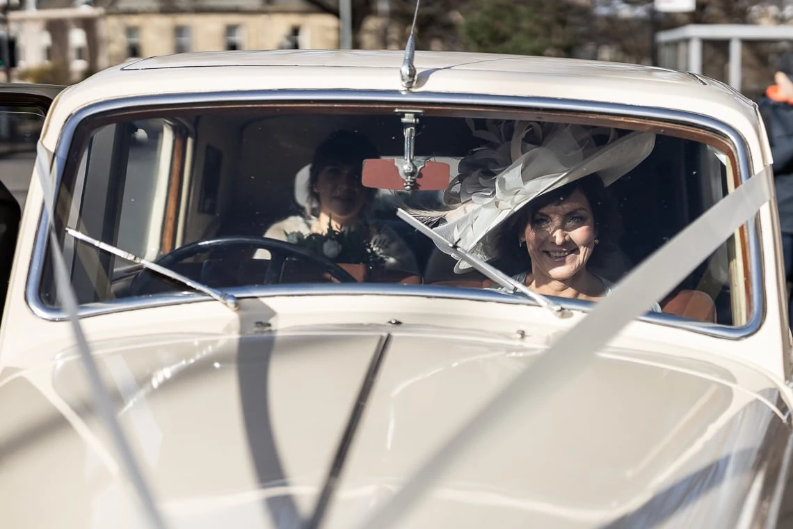 bridesmaids and mother of the bride arriving in a classic Bentley wedding car