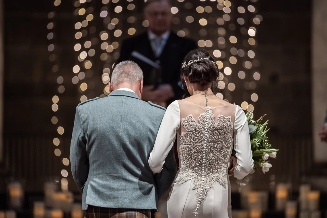father of the bride escorts his daughter to the altar, back of Justin Alexander dress