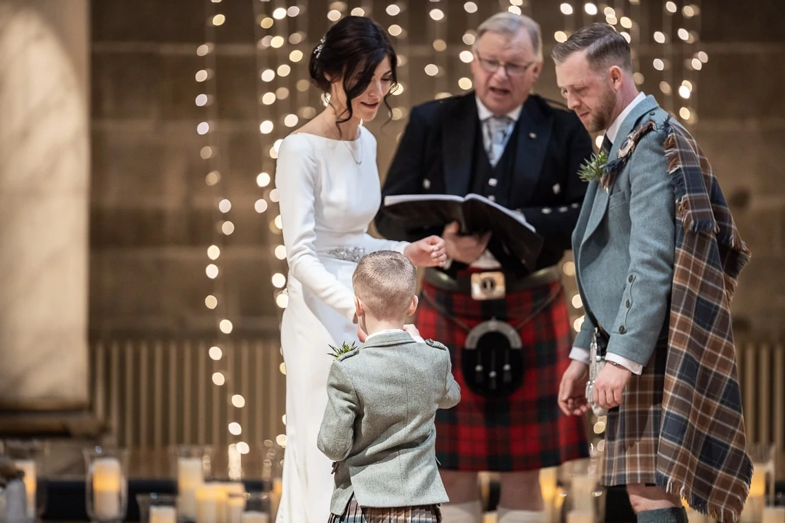 page boy hands ring to bride