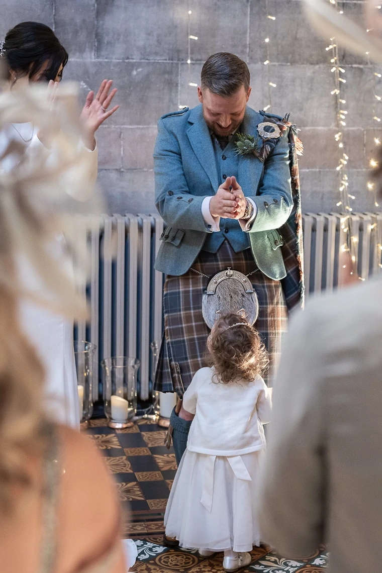 groom applauds his flower girl daughter during her naming ceremony