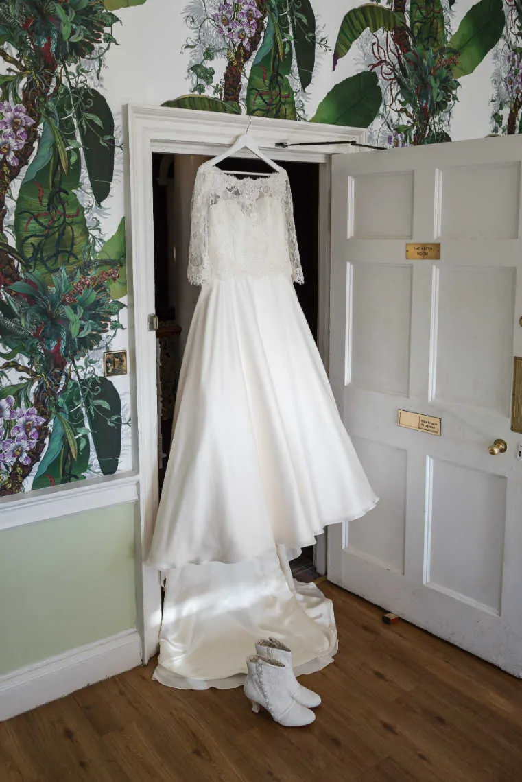 Wedding dress hanging up at doorway