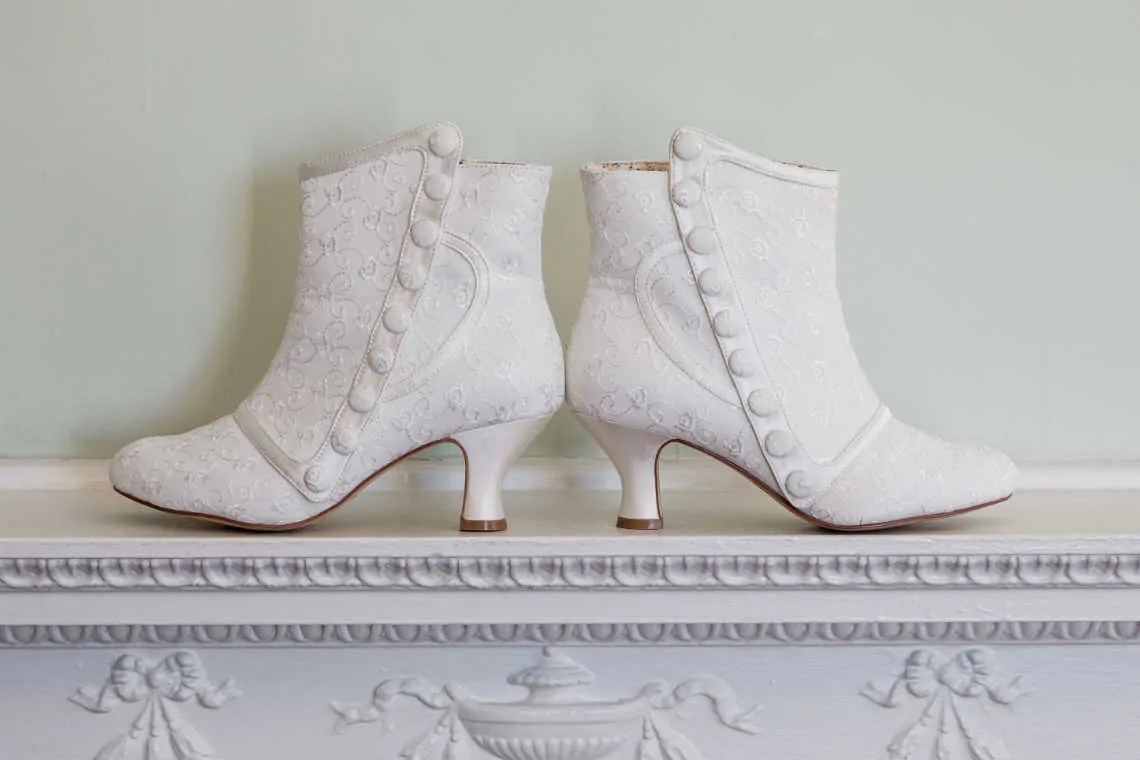 Close up of bride's white wedding boots