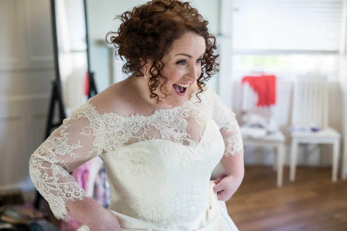 Bride delighted to see the flower girl for the first time