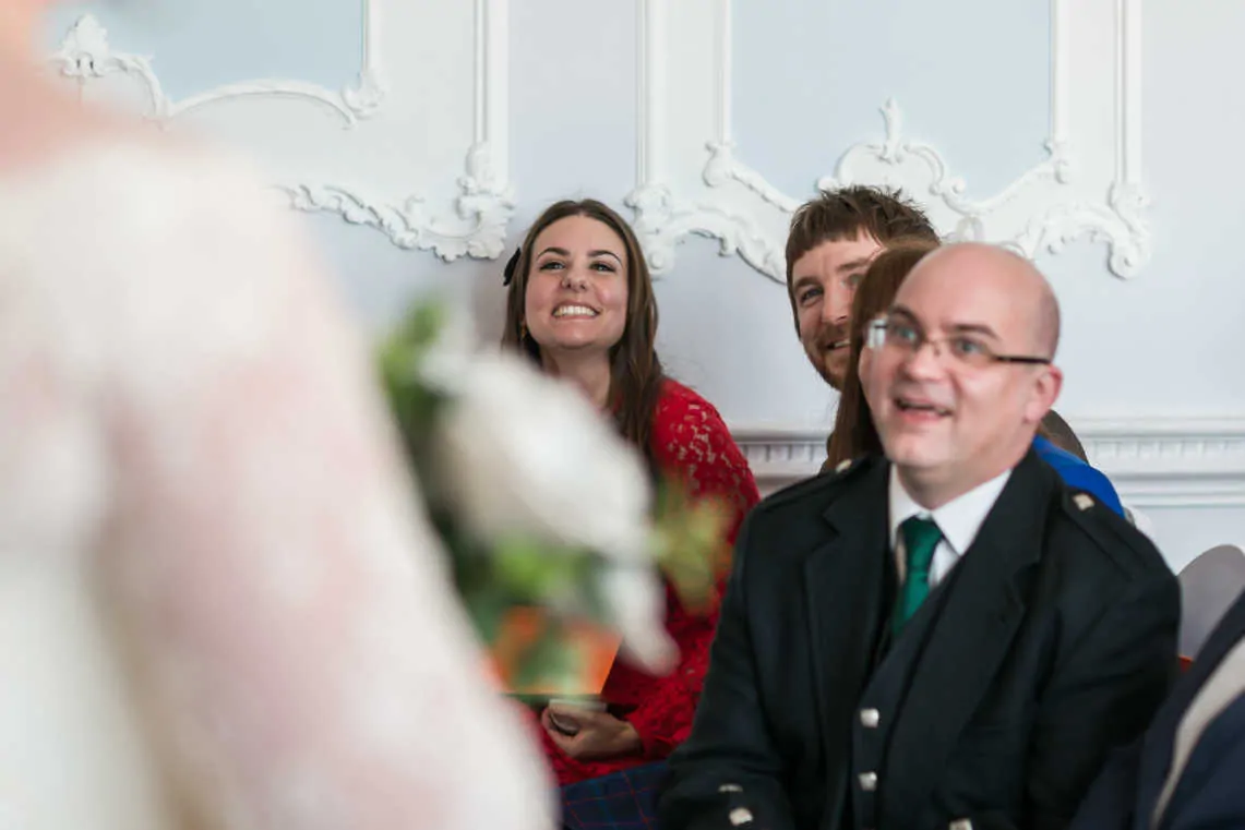 Guests smiling at bride and groom