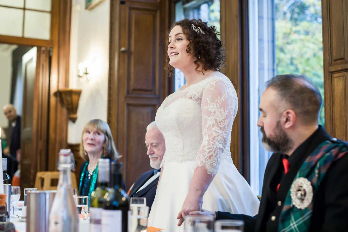 Bride giving speech at wedding reception