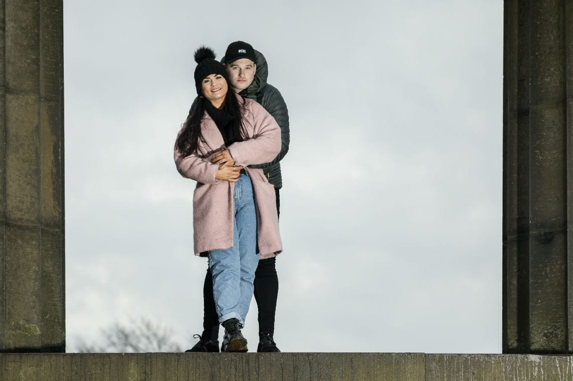 couple embrace on the monument