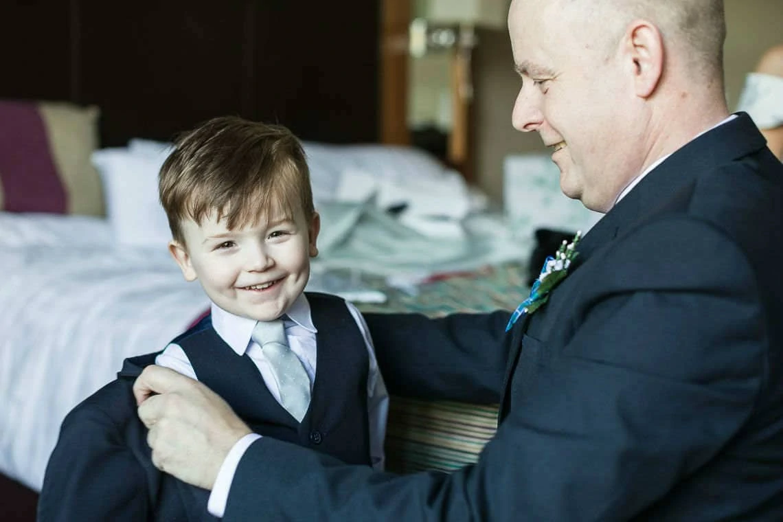 little boy with grandpa getting dressed for wedding