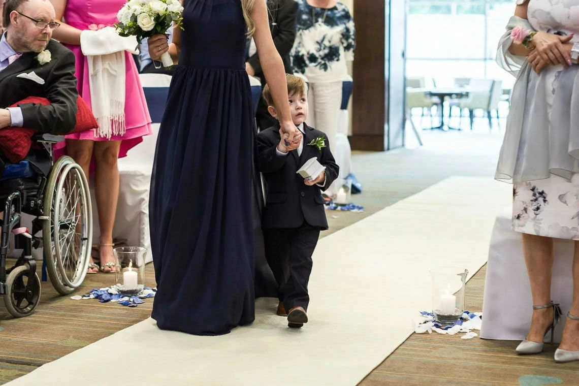 Garden Suite - little boy and bridesmaid walking down the aisle