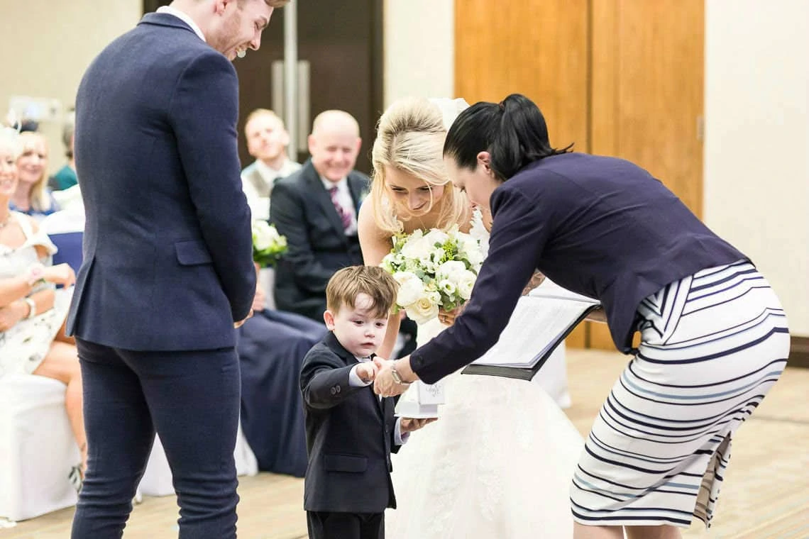 little boy gives wedding rings to humanist celebrant