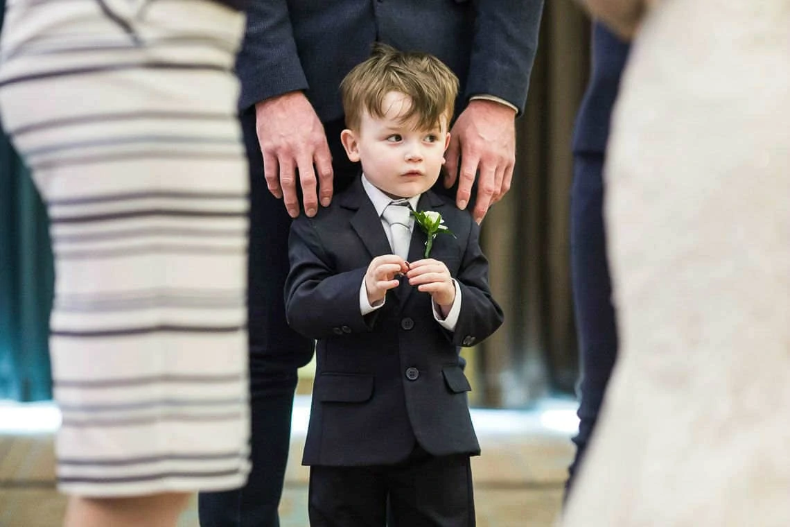 little boy wearing suit with flower buttonhole