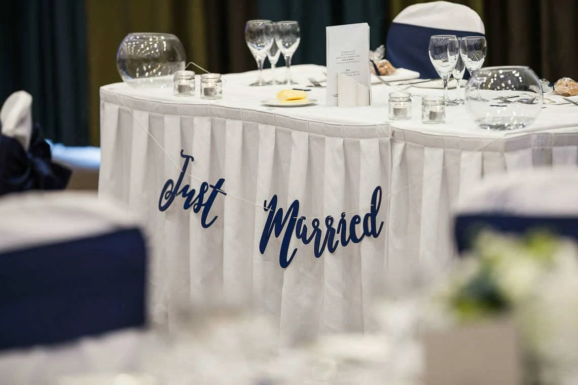 top table with just married navy blue banner at reception