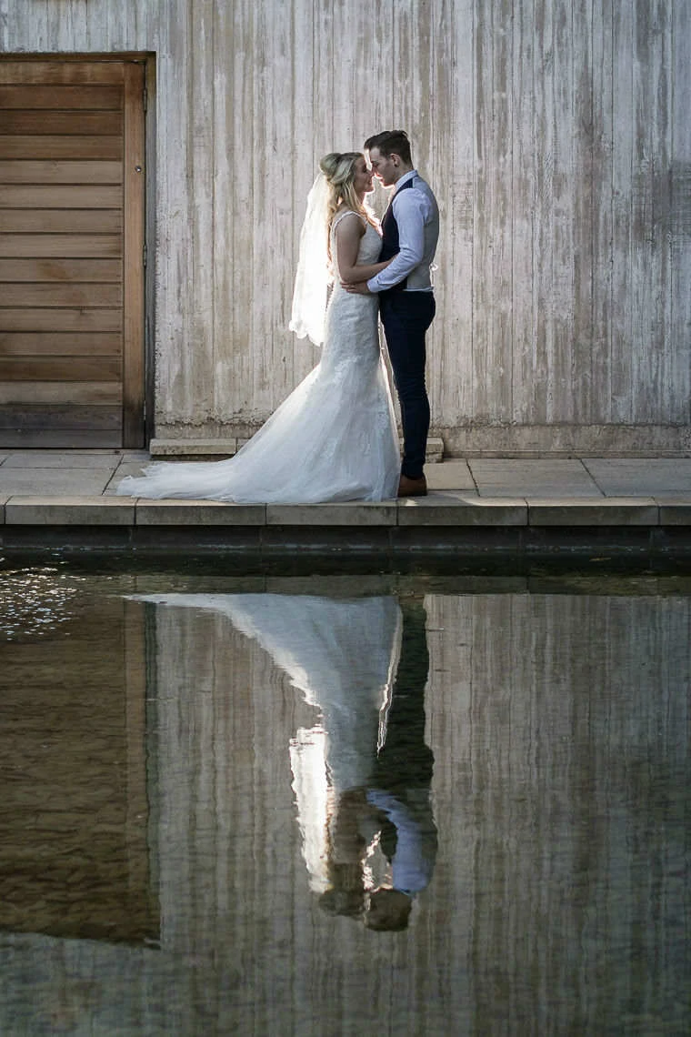 Norton House Hotel Wedding - newlyweds looking at each other in front of water feature