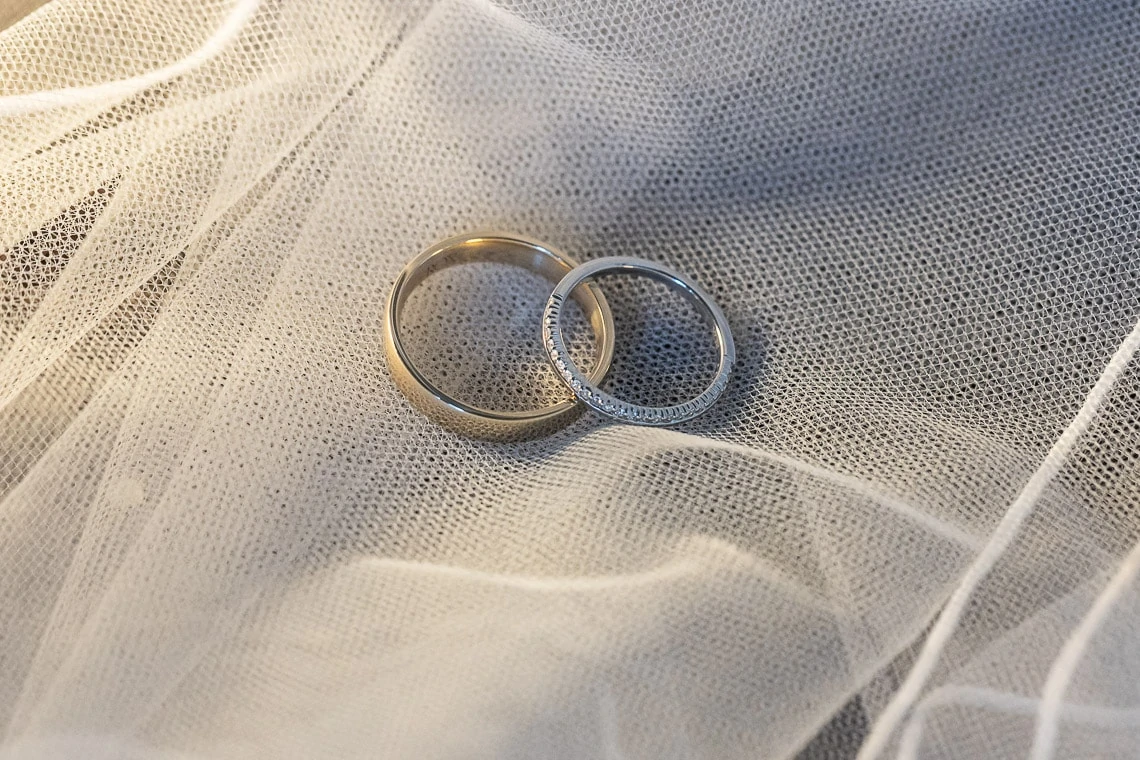 wedding rings laid on the bride's veil