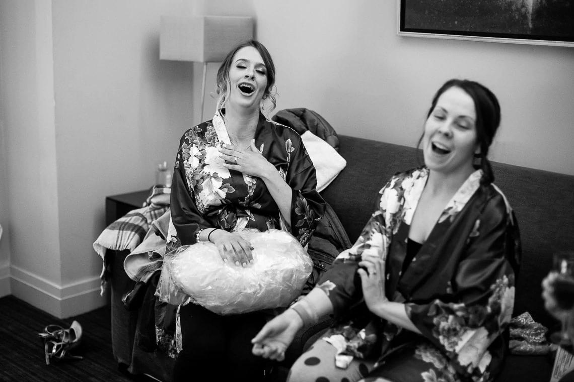 bridesmaids laughing during pre-ceremony preparations